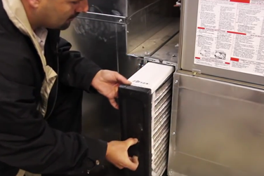 HVAC technician changing air filter